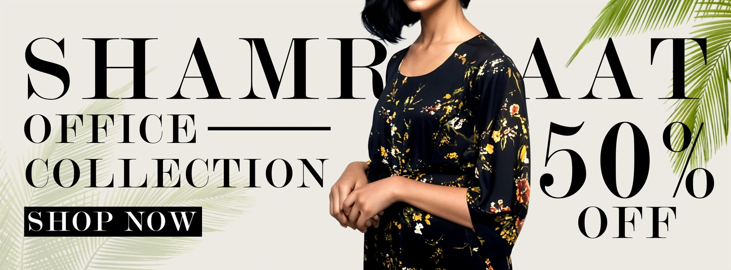 Woman wearing a black floral dress from Shamraat’s Office Collection with 50% off